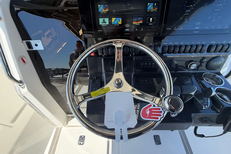 Slide: The Image of Steering wheel and dashboard of 2026 Pursuit S 358 Sport boat with navigation screens. - 77