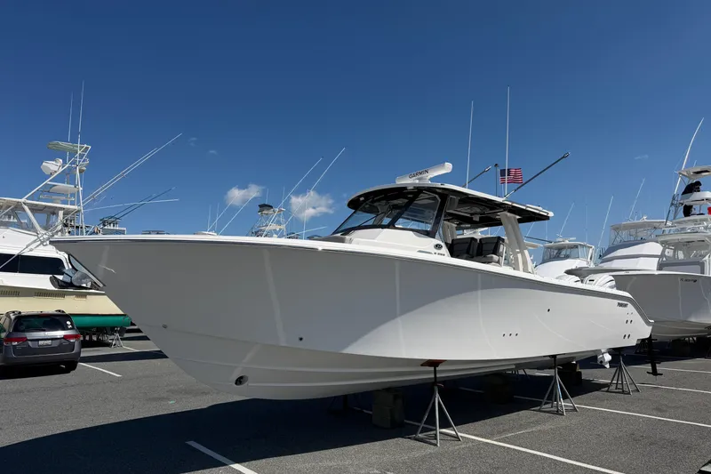 Slide: The Image of 2026 Pursuit S 358 Sport boat displayed in a marina under clear blue skies. - 8