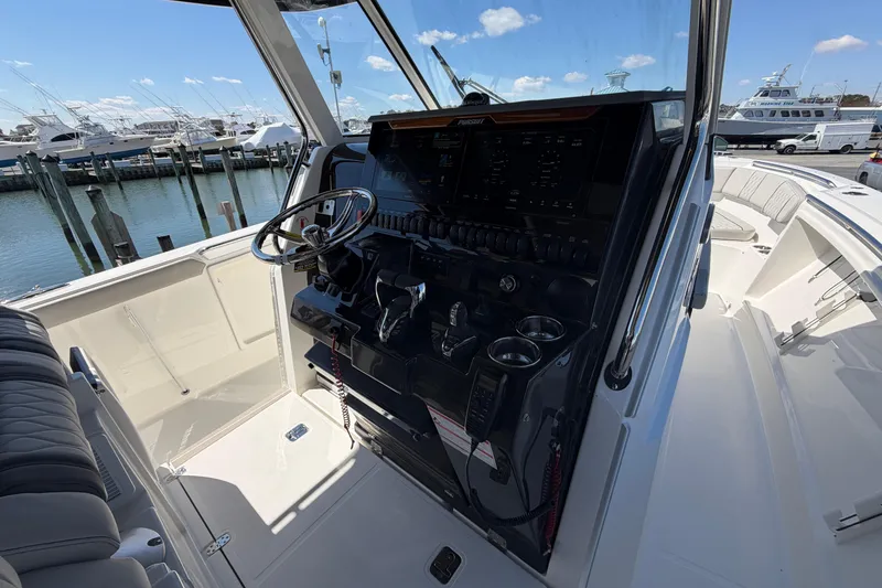 Slide: The Image of Interior view of 2026 Pursuit S 358 Sport boat cockpit with steering wheel and controls. - 81