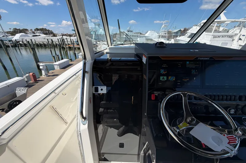 Slide: The Image of Interior view of 2026 Pursuit S 358 Sport boat at marina dock. - 87