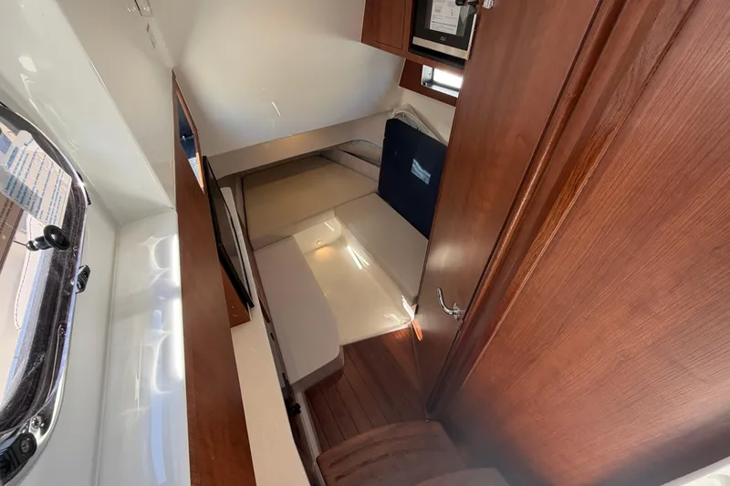Slide: The Image of Interior cabin of 2026 Pursuit S 358 Sport boat with wooden finishes. - 89