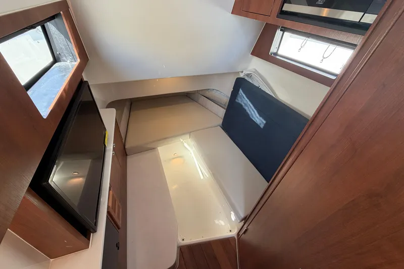 Slide: The Image of Interior cabin of 2026 Pursuit S 358 Sport boat, featuring seating and wood finishes. - 90