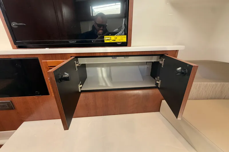 Slide: The Image of Open cabinet in 2026 Pursuit S 358 Sport boat interior, showcasing storage space. - 93