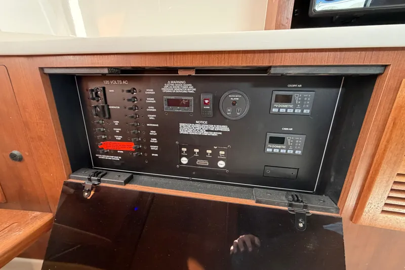 Slide: The Image of Electrical control panel of 2026 Pursuit S 358 Sport boat, featuring switches and displays. - 94