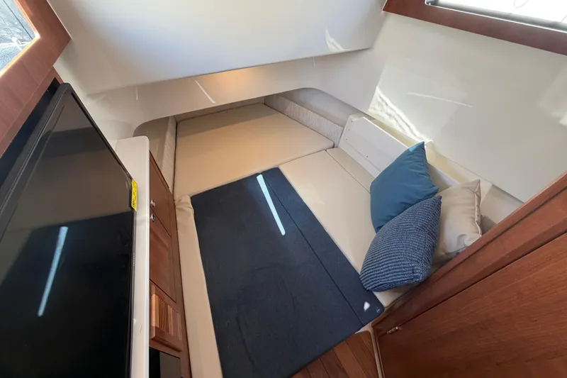 Slide: The Image of Interior cabin of 2026 Pursuit S 358 Sport boat with cozy seating and cushions. - 95