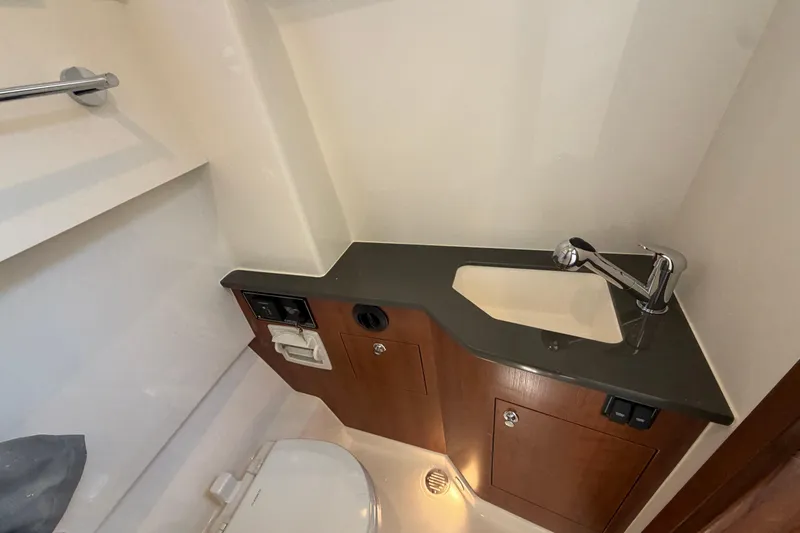 Slide: The Image of 2026 Pursuit S 358 Sport boat bathroom with sink, faucet, and toilet. - 97