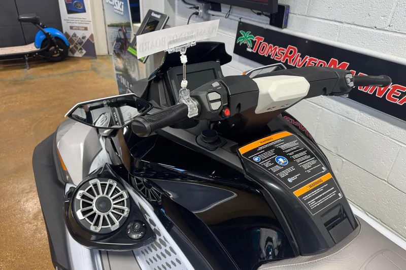 Slide: The Image of 2026 Kawasaki STX160LX jet ski dashboard with controls and warning labels. - 4