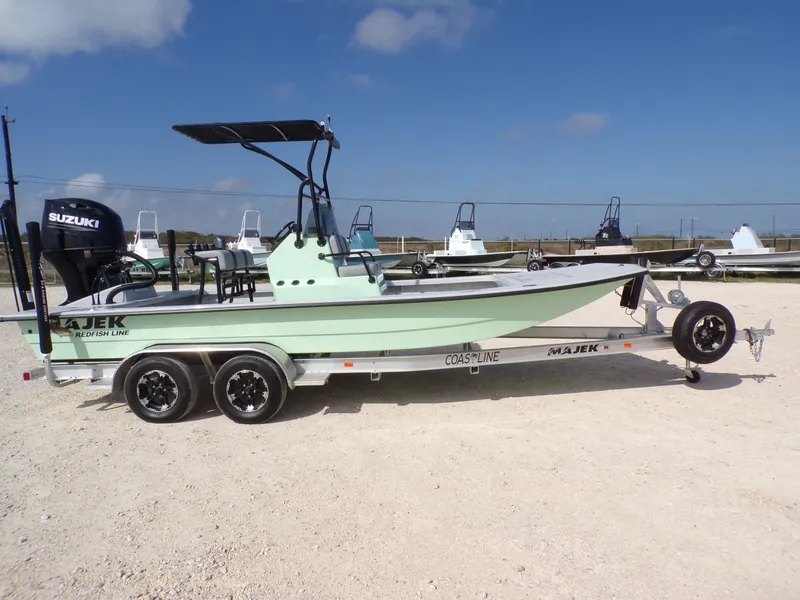 Slide: The Image of 2026 Majek 21 Redfish boat with Suzuki engine on trailer. - 13