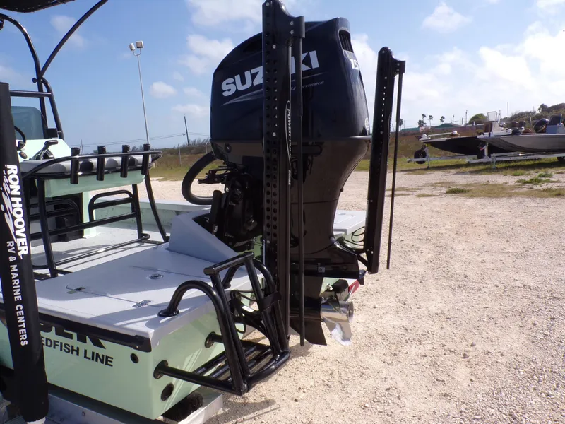 Slide: The Image of Majek 21 Redfish 2026 with Suzuki engine on gravel lot. - 28