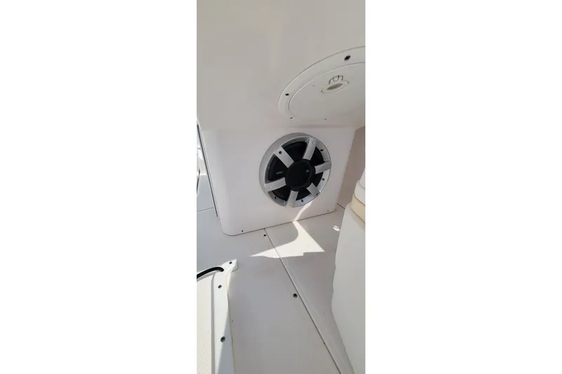 Slide: The Image of Speaker and blue cushion on 2013 Everglades 230 Dual Console boat interior. - 11