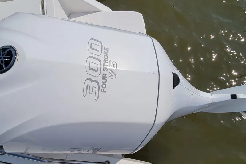 Slide: The Image of 2013 Everglades 230 Dual Console boat interior with seating and water view. - 13