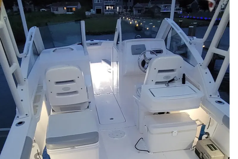 Slide: The Image of 2013 Everglades 230 Dual Console boat interior with illuminated seating and steering area. - 15