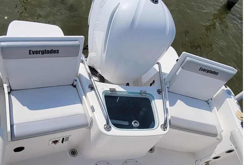 Slide: The Image of 2013 Everglades 230 Dual Console boat interior with seating and storage compartments. - 4