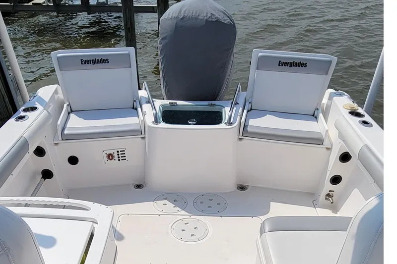 Slide: The Image of 2013 Everglades 230 Dual Console boat interior with seating and illuminated deck. - 5