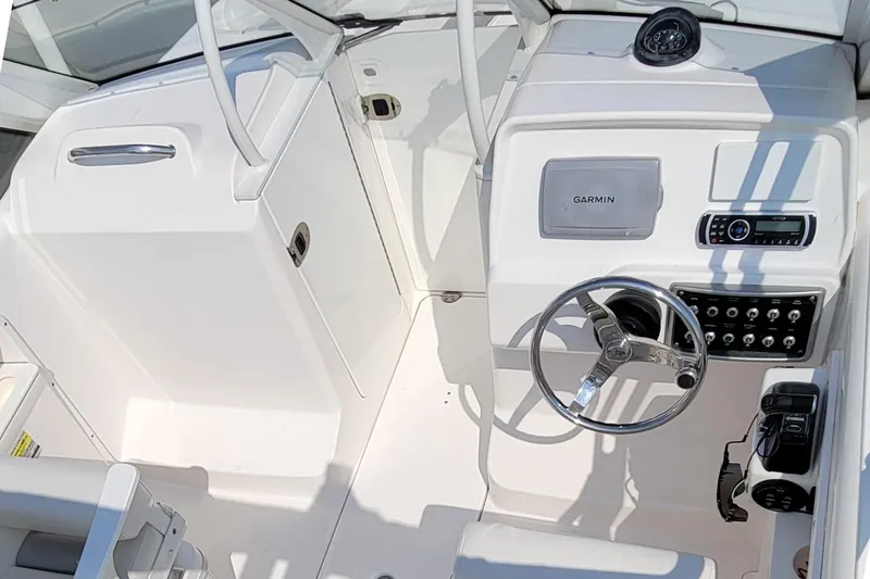 Slide: The Image of 2013 Everglades 230 Dual Console boat cockpit with Garmin navigation and steering wheel. - 6