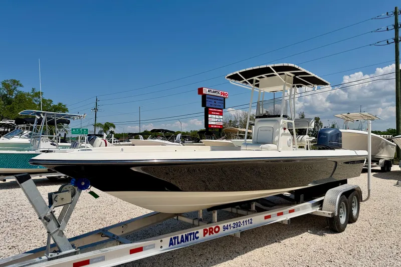 Slide: The Image of 2008 ShearWater 2400Z boat on trailer at dealership under clear blue sky. - 1