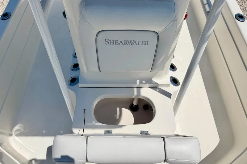 Slide: The Image of 2008 ShearWater 2400Z boat interior with seating and storage compartment. - 10