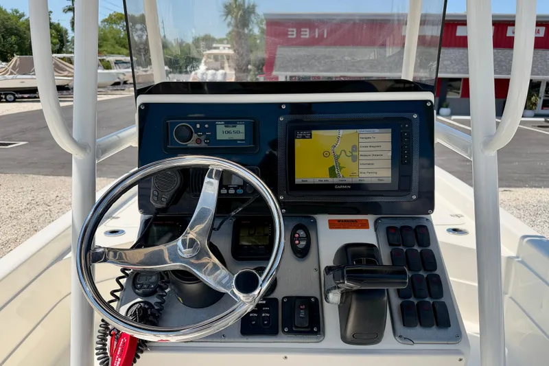Slide: The Image of Console of a 2008 ShearWater 2400Z boat with steering wheel and navigation system. - 14