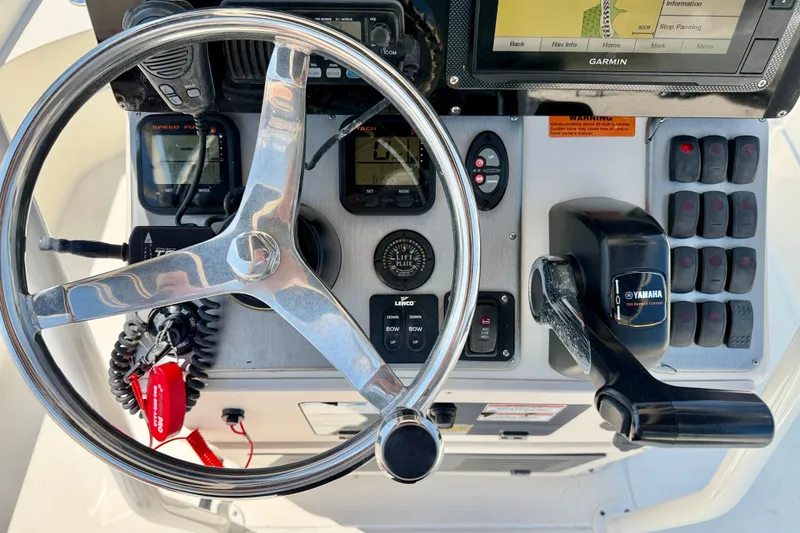 Slide: The Image of Steering console of a 2008 ShearWater 2400Z boat with Yamaha controls and Garmin display. - 15