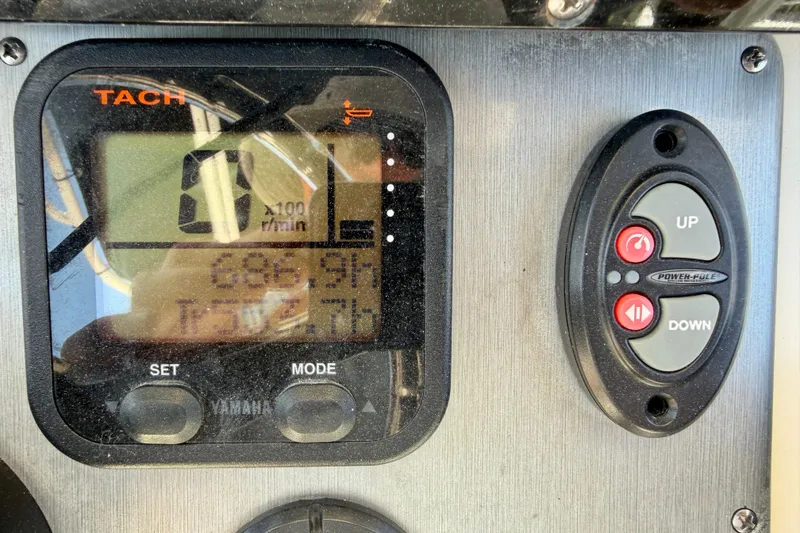 Slide: The Image of Close-up of a 2008 ShearWater 2400Z boat tachometer and control panel. - 19