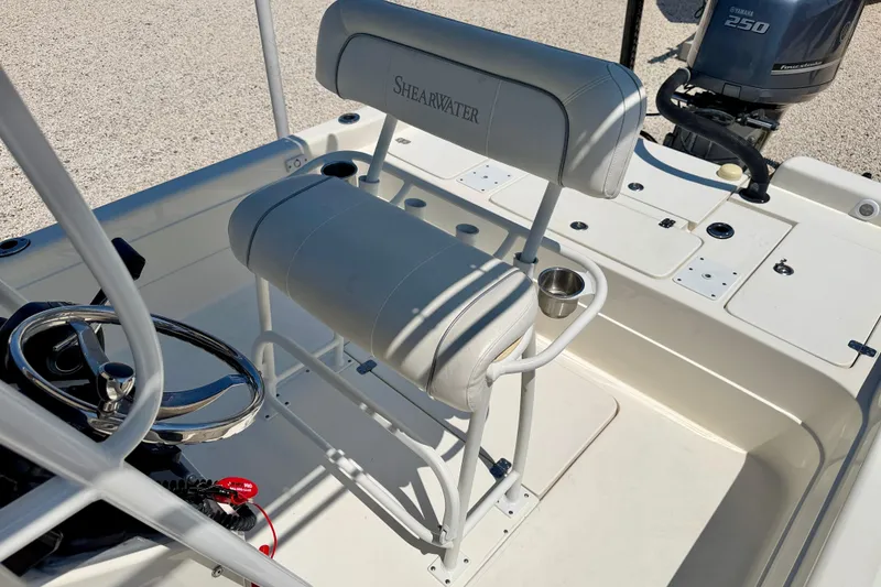 Slide: The Image of 2008 ShearWater 2400Z boat interior with steering wheel and seating. - 20