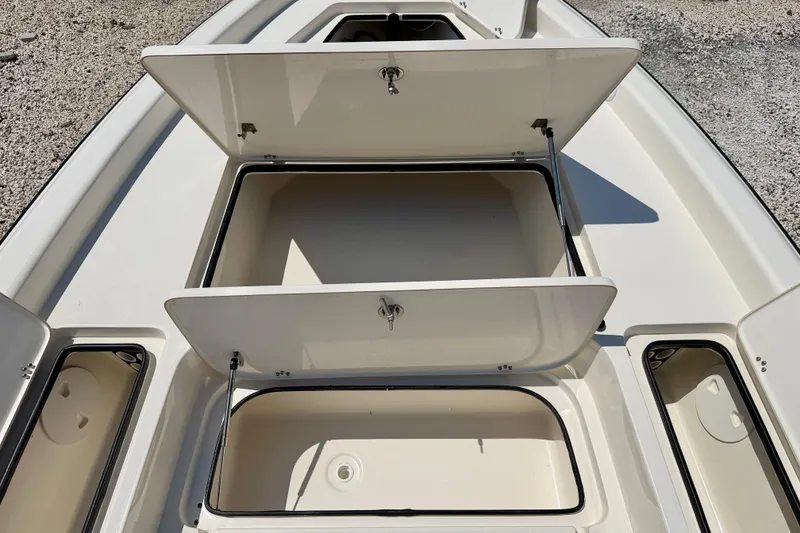Slide: The Image of Open storage compartments on a 2008 ShearWater 2400Z boat deck. - 24