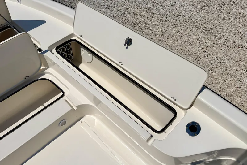 Slide: The Image of Open storage compartments on a 2008 ShearWater 2400Z boat deck. - 26