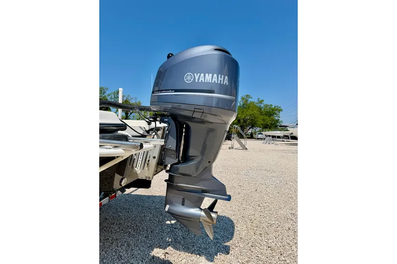 Slide: The Image of Yamaha outboard motor on 2008 ShearWater 2400Z boat, parked on gravel under clear blue sky. - 34