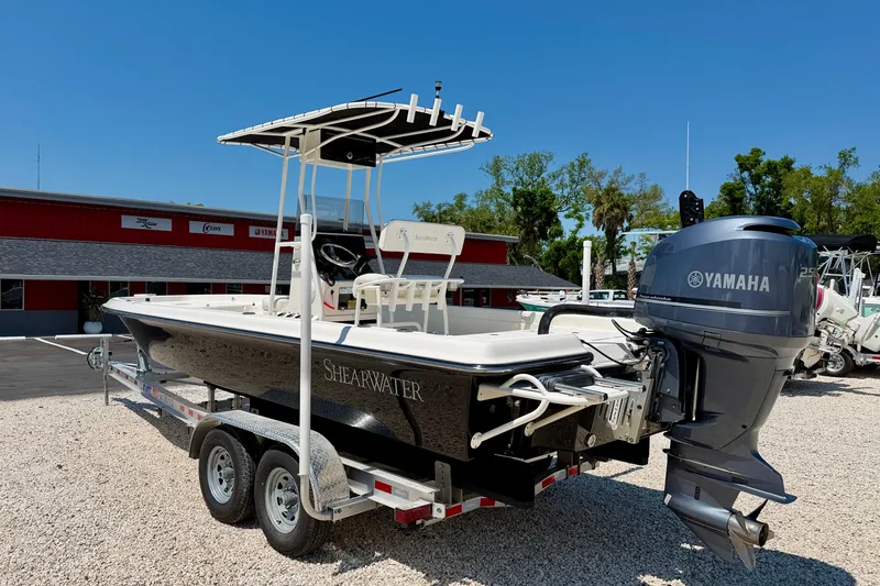 Slide: The Image of 2008 ShearWater 2400Z boat with Yamaha engine on trailer, parked outdoors. - 7