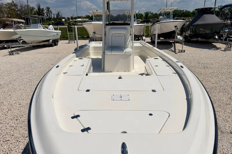 Slide: The Image of 2008 ShearWater 2400Z boat on display in a gravel lot with other boats. - 8