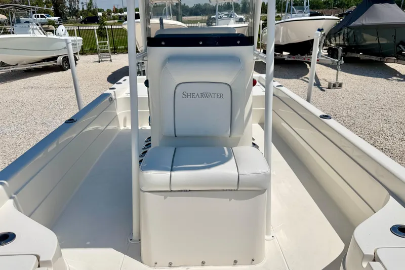 Slide: The Image of 2008 ShearWater 2400Z boat interior with white seating and clean deck. - 9