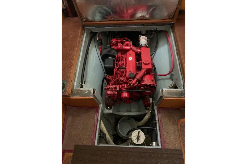 Slide: The Image of Red engine inside a 1960 Rhodes Bounty boat, with visible wiring and components. - 13