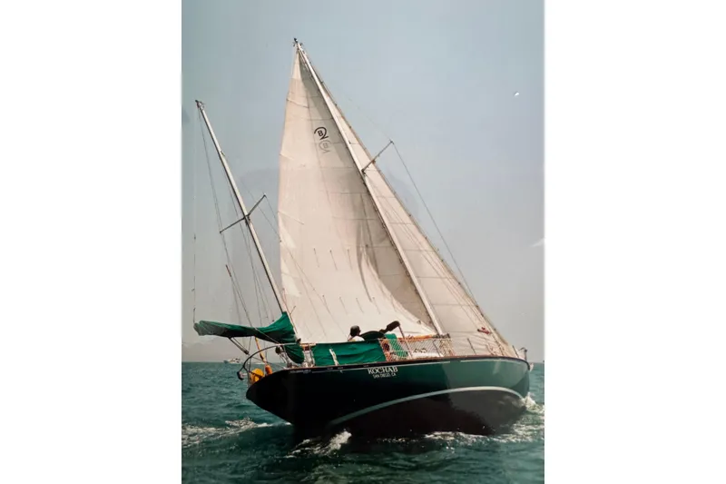 Slide: The Image of Vintage 1960 Rhoads Bounty sailboat navigating open waters with full sails. - 2