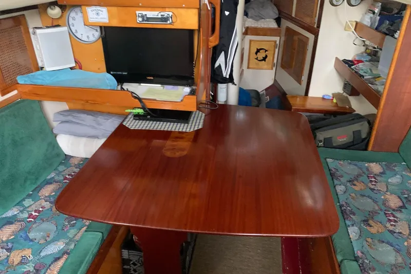 Slide: The Image of 1960 Rhodes Bounty interior with wooden table, seating, and nautical decor. - 8