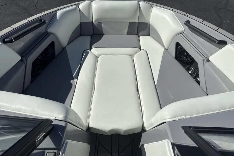Slide: The Image of 2025 Moomba Craz boat interior with white cushioned seating and sleek design. - 11