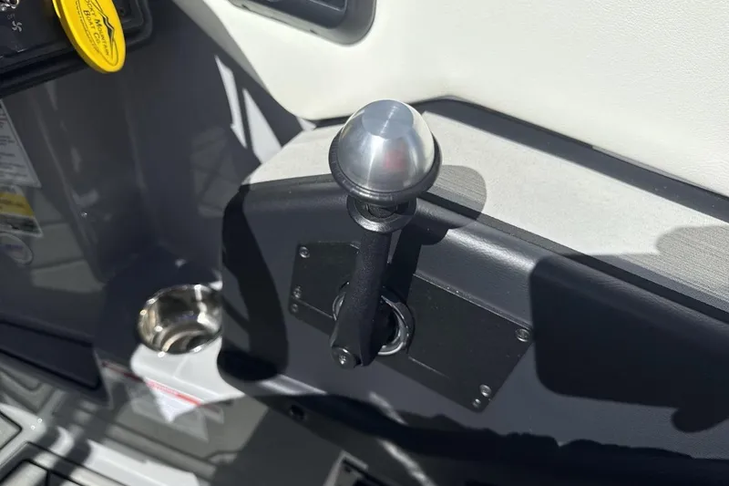 Slide: The Image of 2025 Moomba Craz boat throttle control lever with metallic knob and cup holder. - 16