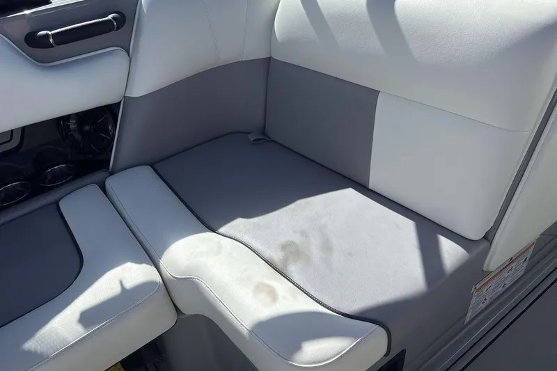 Slide: The Image of 2025 Moomba Craz boat interior with gray and white seating, featuring cup holders and sleek design. - 17