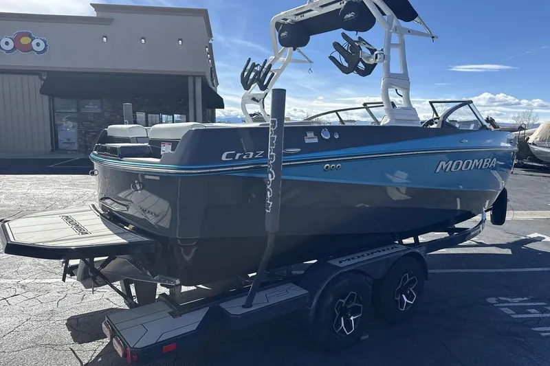Slide: The Image of 2025 Moomba Craz boat on trailer, parked outdoors, showcasing sleek design and vibrant colors. - 5