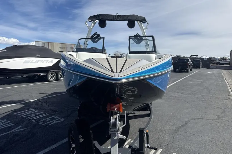 Slide: The Image of 2025 Moomba Craz boat on trailer, parked outdoors under clear sky. - 8