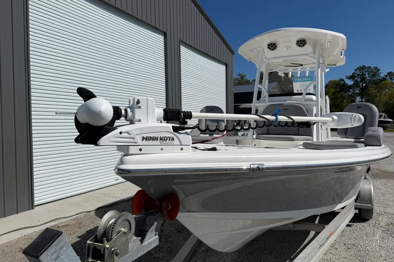 Slide: The Image of 2021 Sea Pro 248 Bay boat with Minn Kota trolling motor, parked on a trailer. - 15