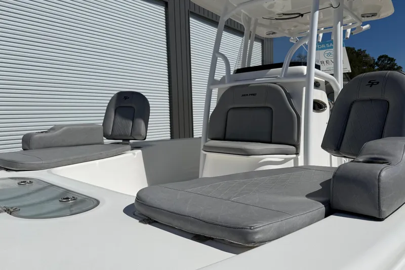 Slide: The Image of 2021 Sea Pro 248 Bay boat with gray seating, showcased outdoors. - 17