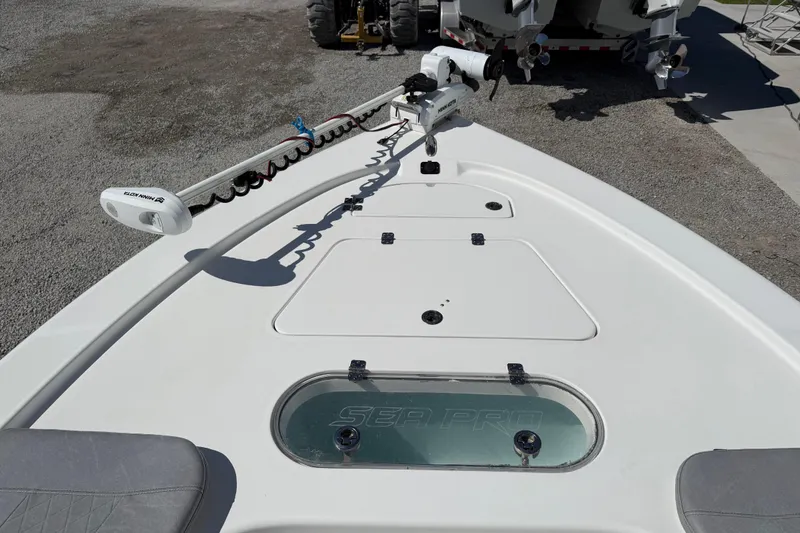 Slide: The Image of 2021 Sea Pro 248 Bay boat deck with trolling motor and storage compartments. - 20