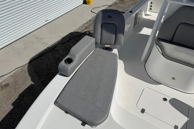 Slide: The Image of 2021 Sea Pro 248 Bay boat interior with gray seating and cup holder. - 22