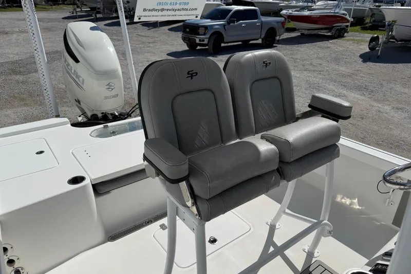 Slide: The Image of 2021 Sea Pro 248 Bay boat interior with dual seats and Suzuki engine. - 25