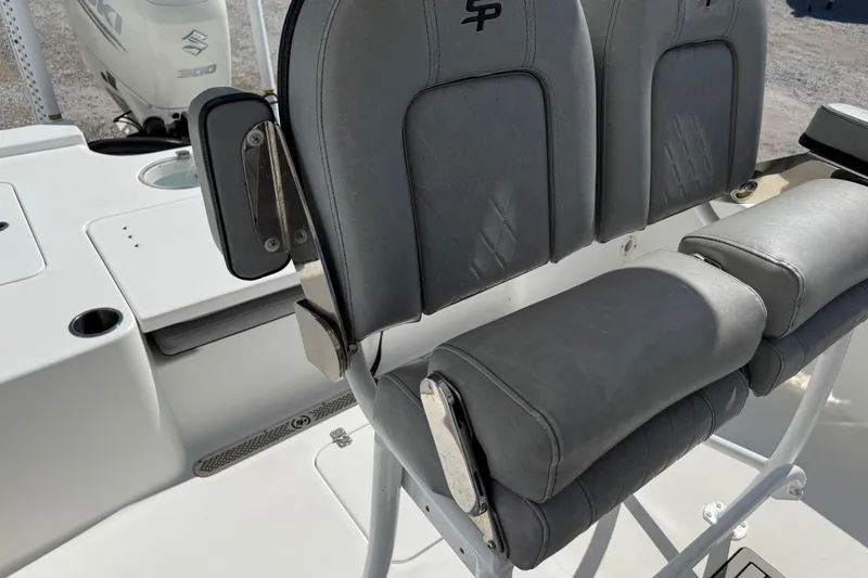 Slide: The Image of 2021 Sea Pro 248 Bay boat seating with gray upholstery and armrests. - 27