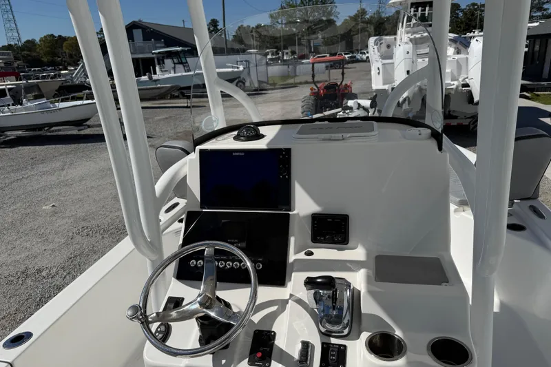 Slide: The Image of 2021 Sea Pro 248 Bay boat dashboard with steering wheel and navigation system. - 32