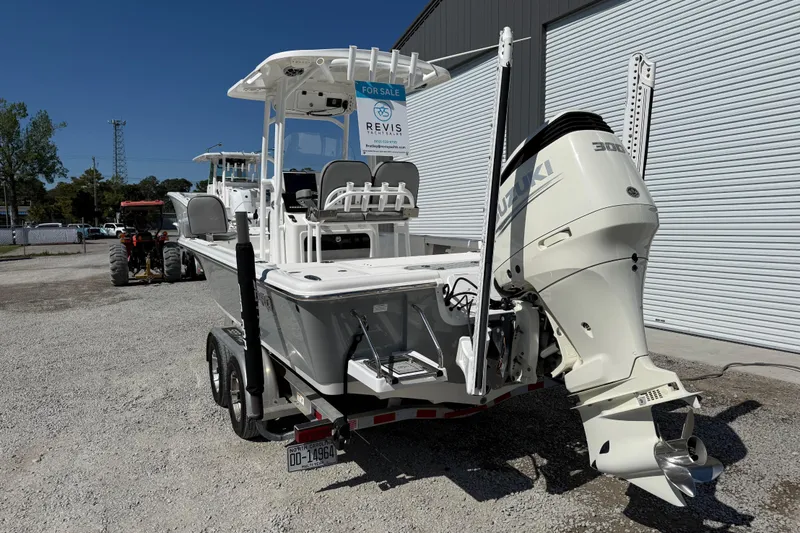 Slide: The Image of 2021 Sea Pro 248 Bay boat with Suzuki 300 engine, parked on a trailer. - 4