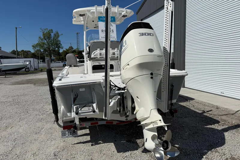 Slide: The Image of 2021 Sea Pro 248 Bay boat with powerful 300 HP engine, parked outdoors. - 5