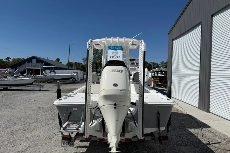 Slide: The Image of 2021 Sea Pro 248 Bay boat for sale, parked outdoors near a storage facility. - 6