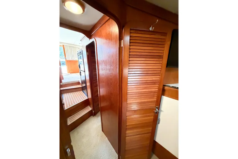 Slide: The Image of Interior of 1988 Pacemaker 36 Convertible yacht with wooden paneling and carpeted flooring. - 100